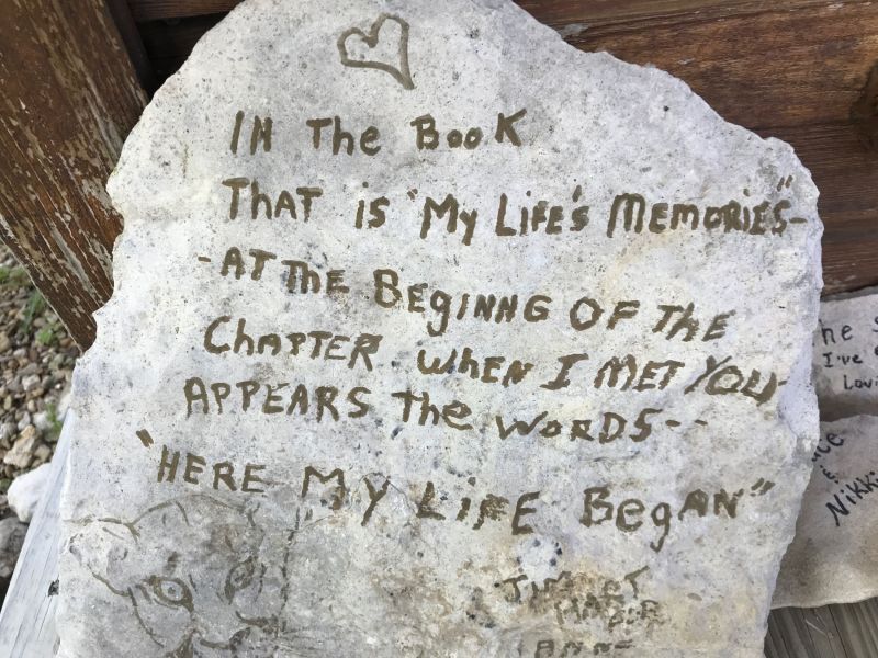Scattered around the base of the cabin are stones people have written messages on memorializing their stay.