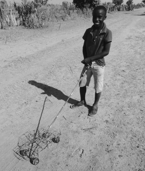 Children playing in the road- the African version of a remote controlled car